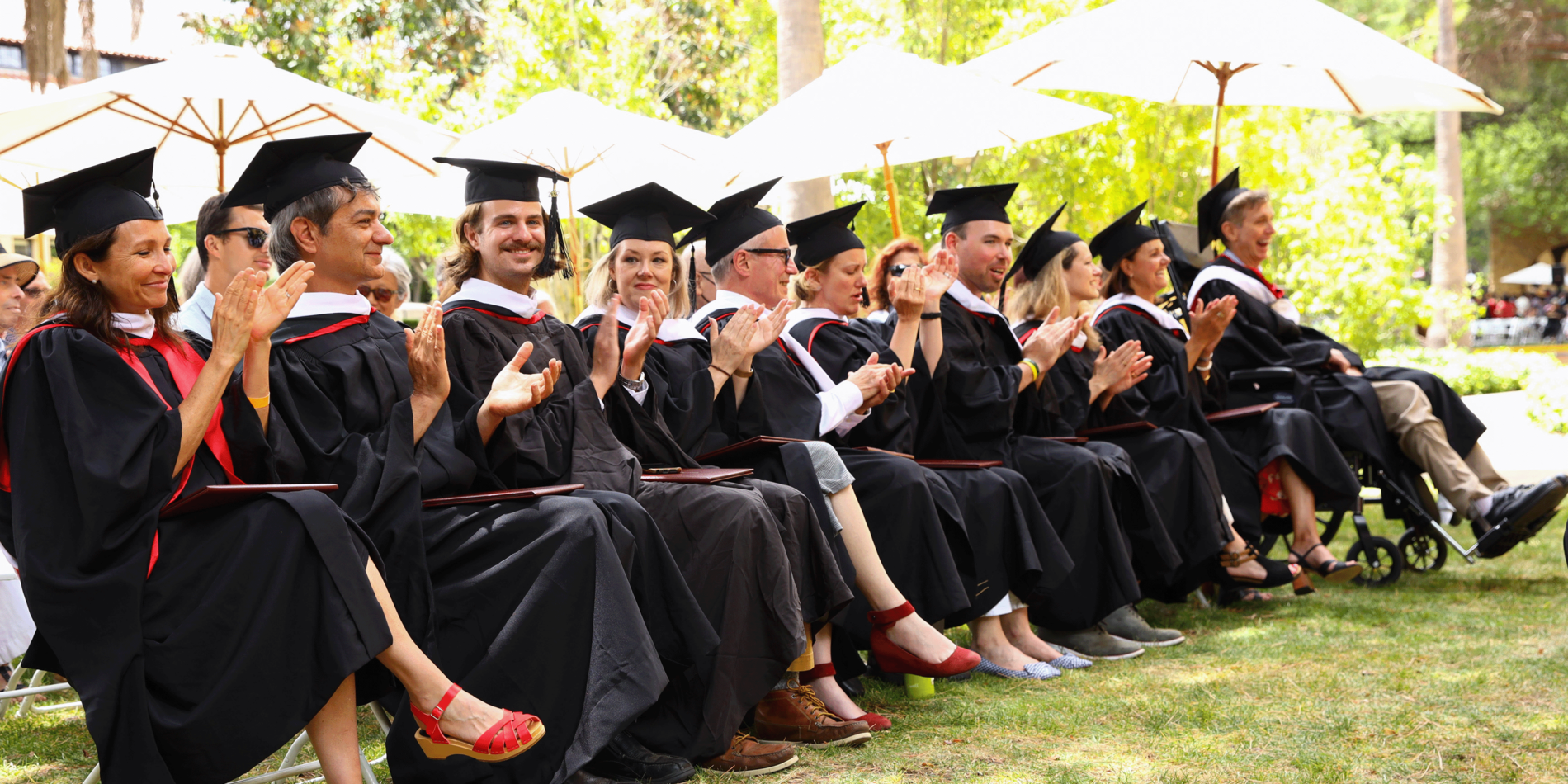 a group of graduates in graduation cap and gown