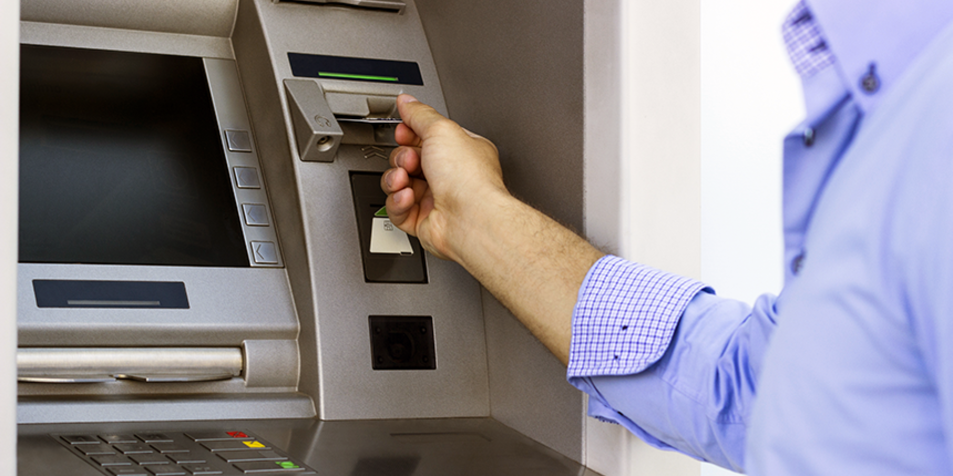 Person putting in card in ATM
