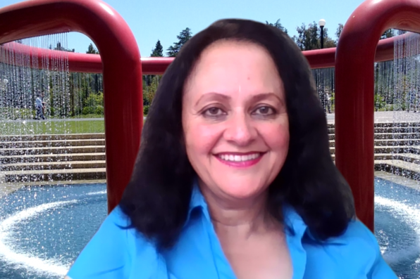 Apama Sharma with virtual background of Stanford libraries fountain
