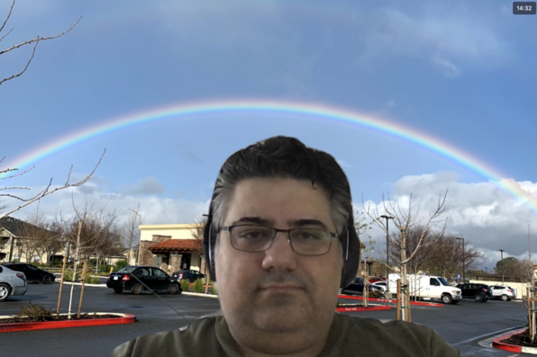 Arash Hooshyari with virtual background of rainbow