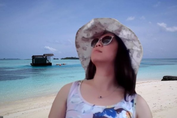 Cathy Lu with virtual background of Maldives