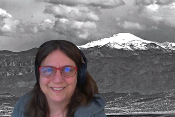Jean Sullivan with virtual background of Colorado mountains
