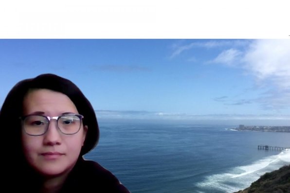Joanie Ly with virtual background of a San Diego beachside
