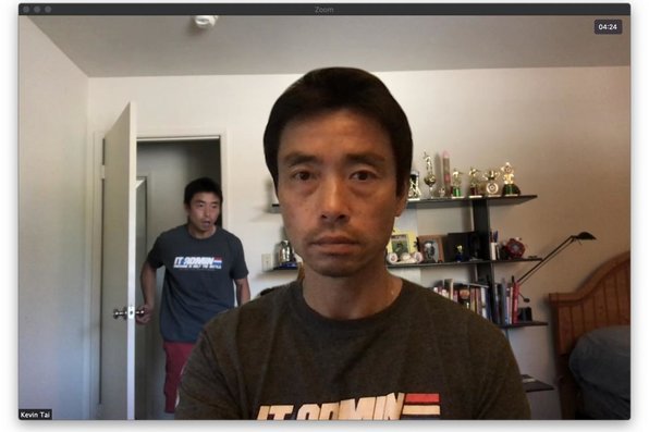 Kevin Tai with virtual background of himself walking into the room