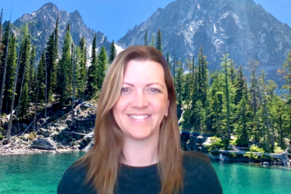 Lisa Boesch with a virtual background of a lake