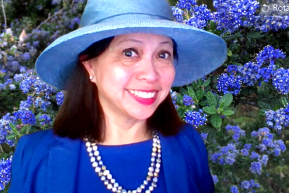 Mary Beth Lefebvre with a virtual background of blue flowers