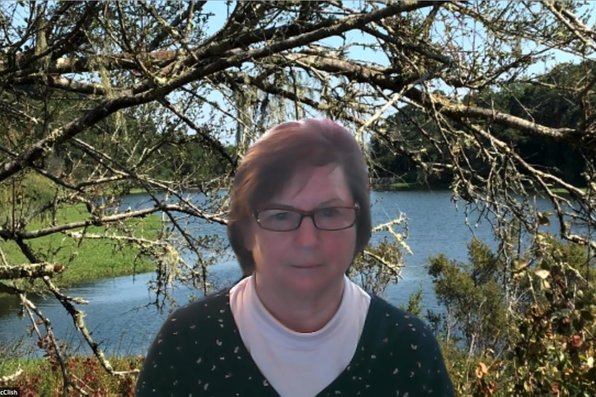 Robin McClish with a virtual background of a lake