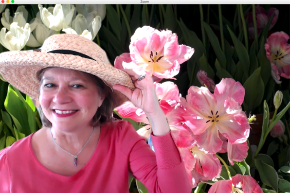 Rossella Derickson with a virtual background of tulips