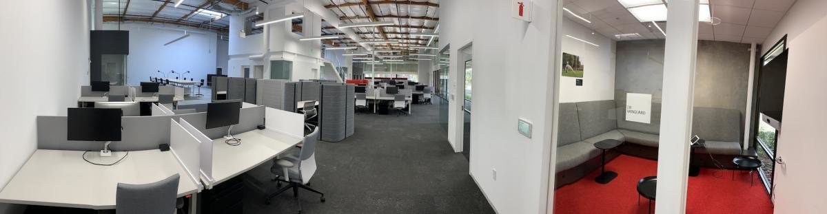 Inside of a work building showing desks and workspaces